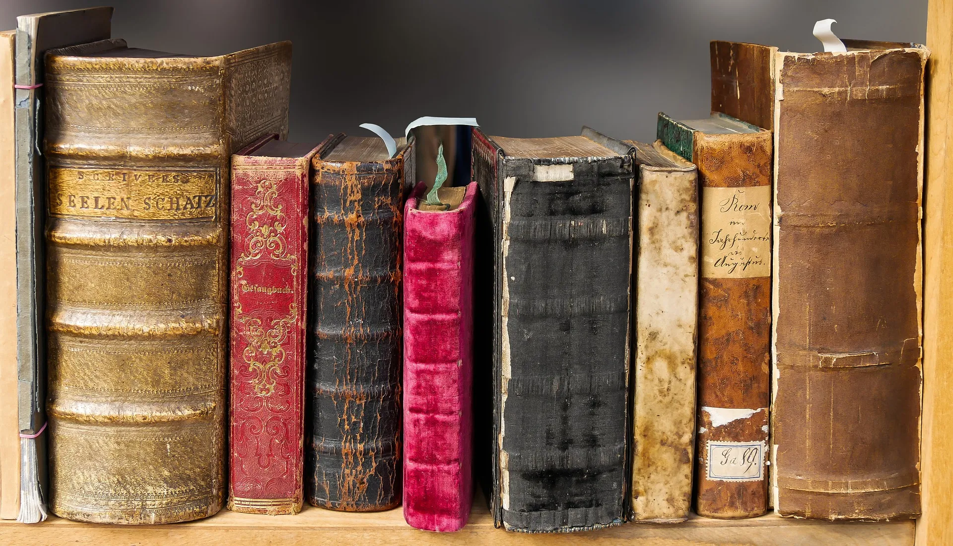 Stack of classic literature books on a wooden desk